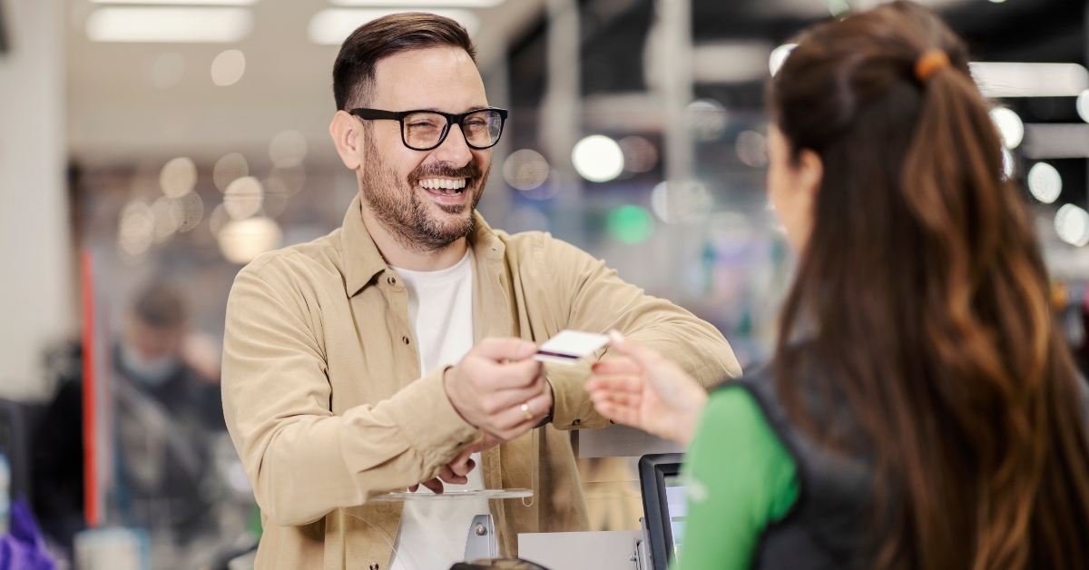 man giving credit card to cashier