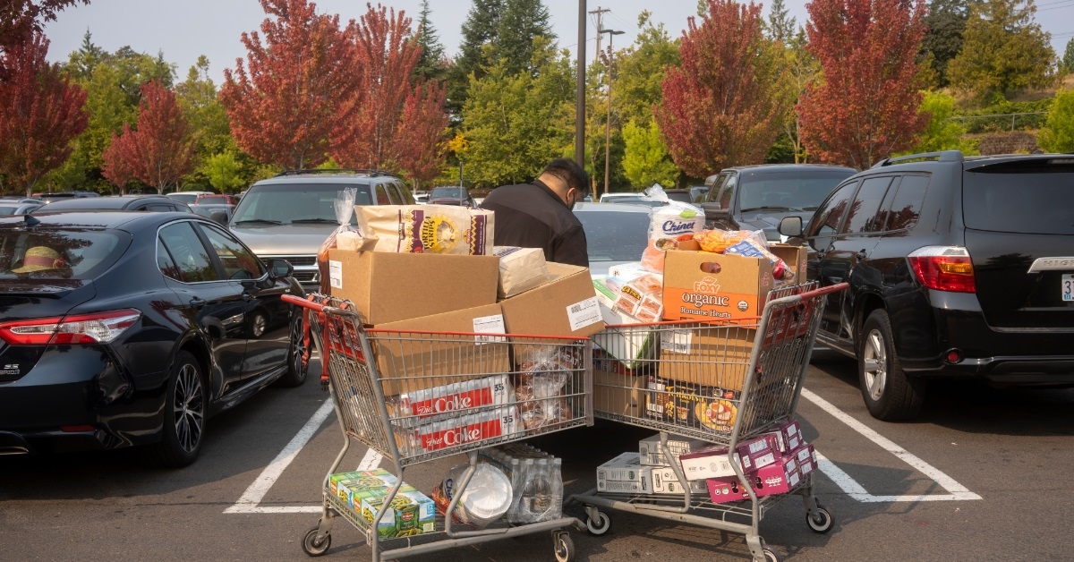 man loading groceries in car