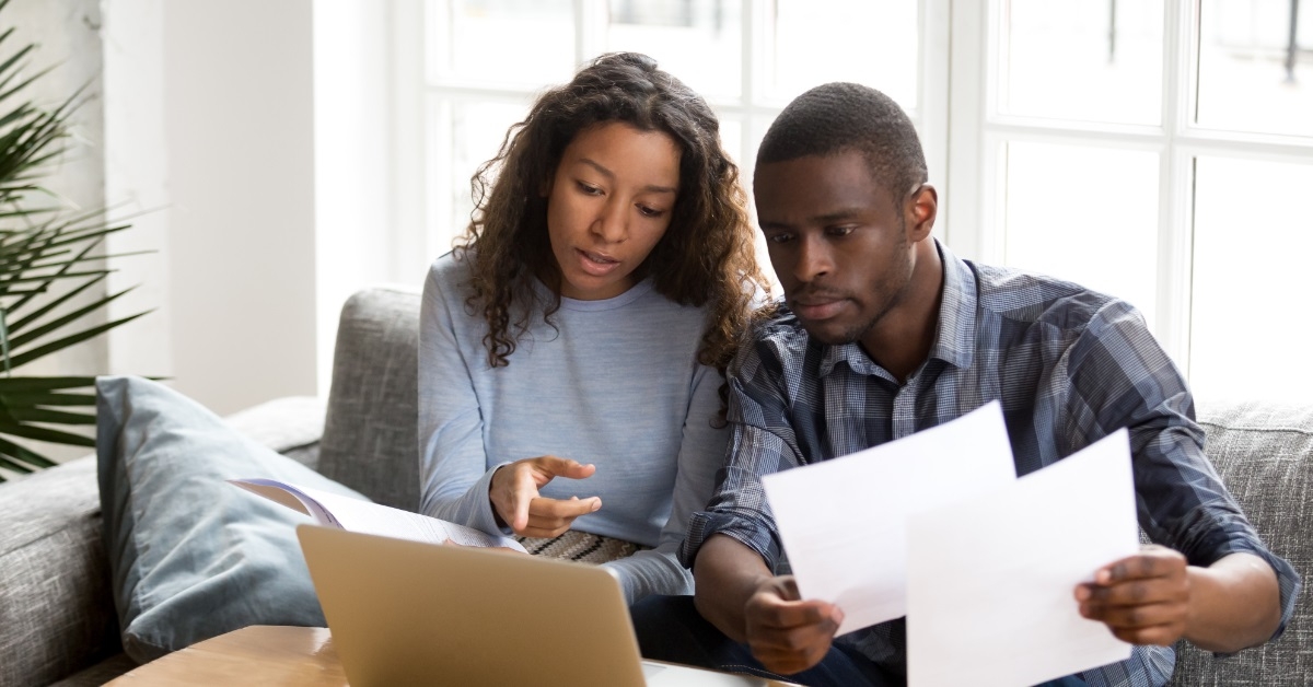 african american couple reviewing bills together