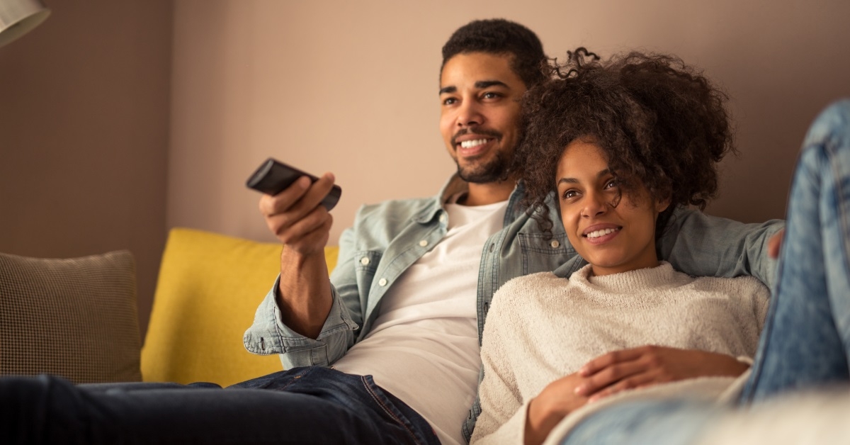 african american couple watching tv together