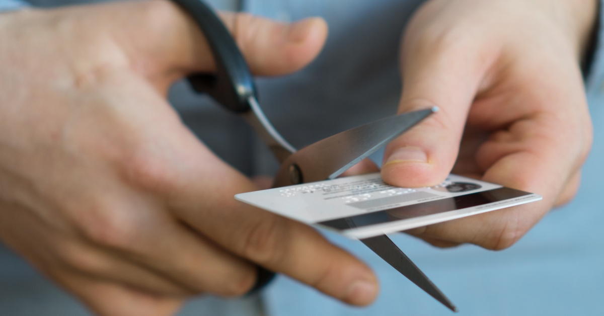 cutting credit card with scissors