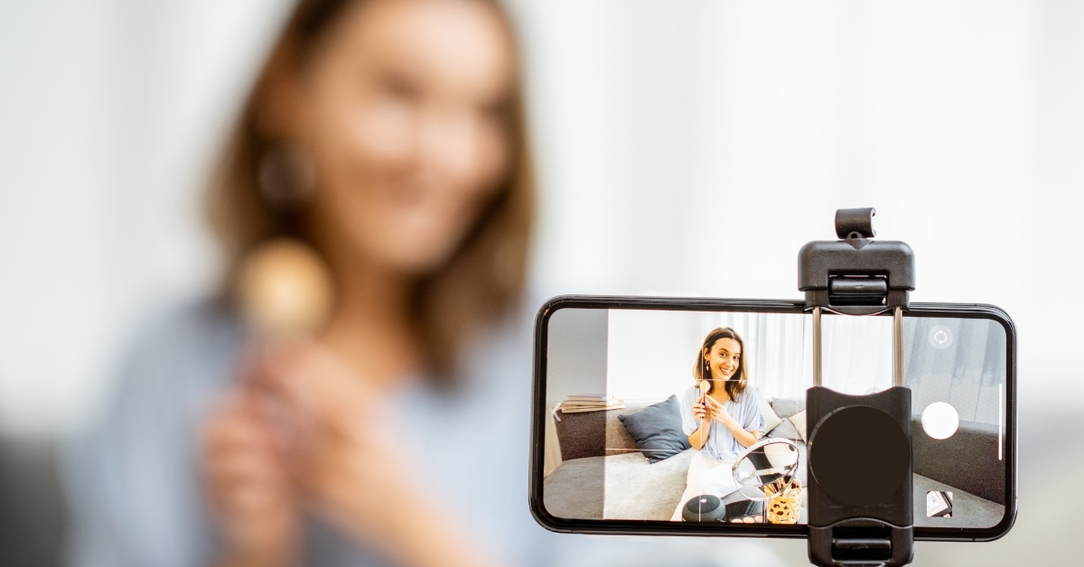 female youtuber recording video on smartphone