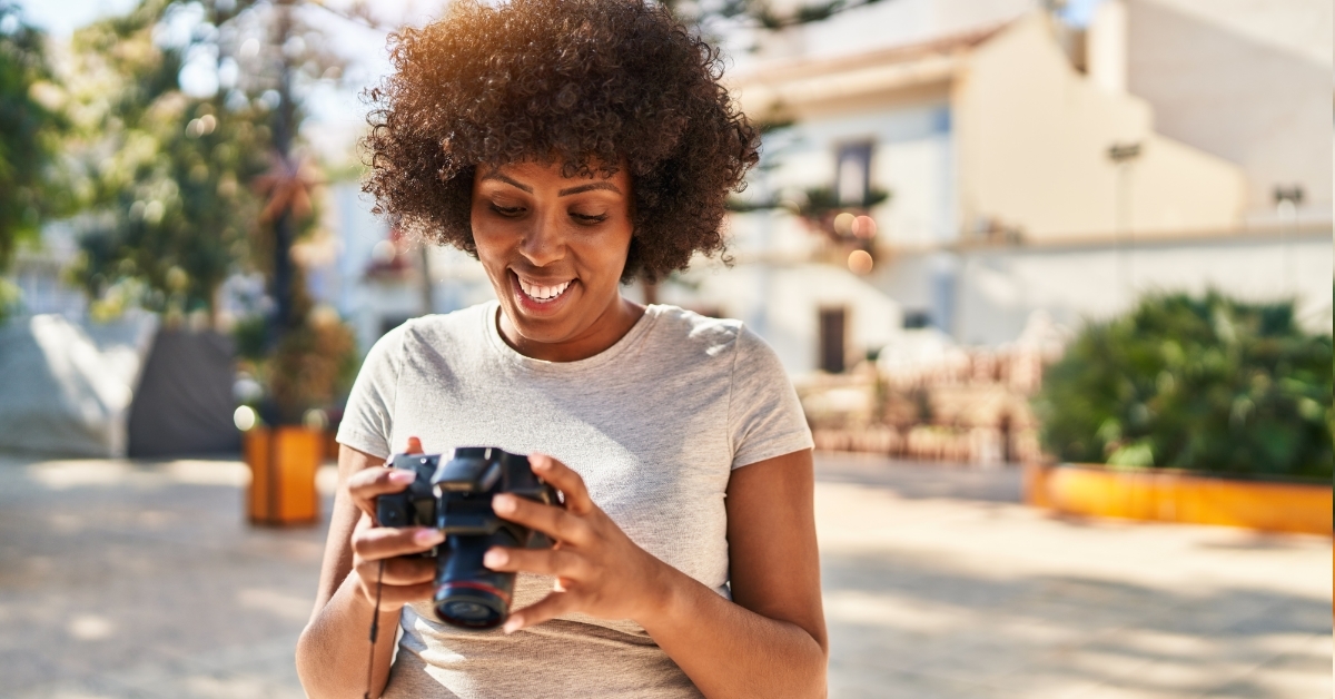African American female photographer using camera