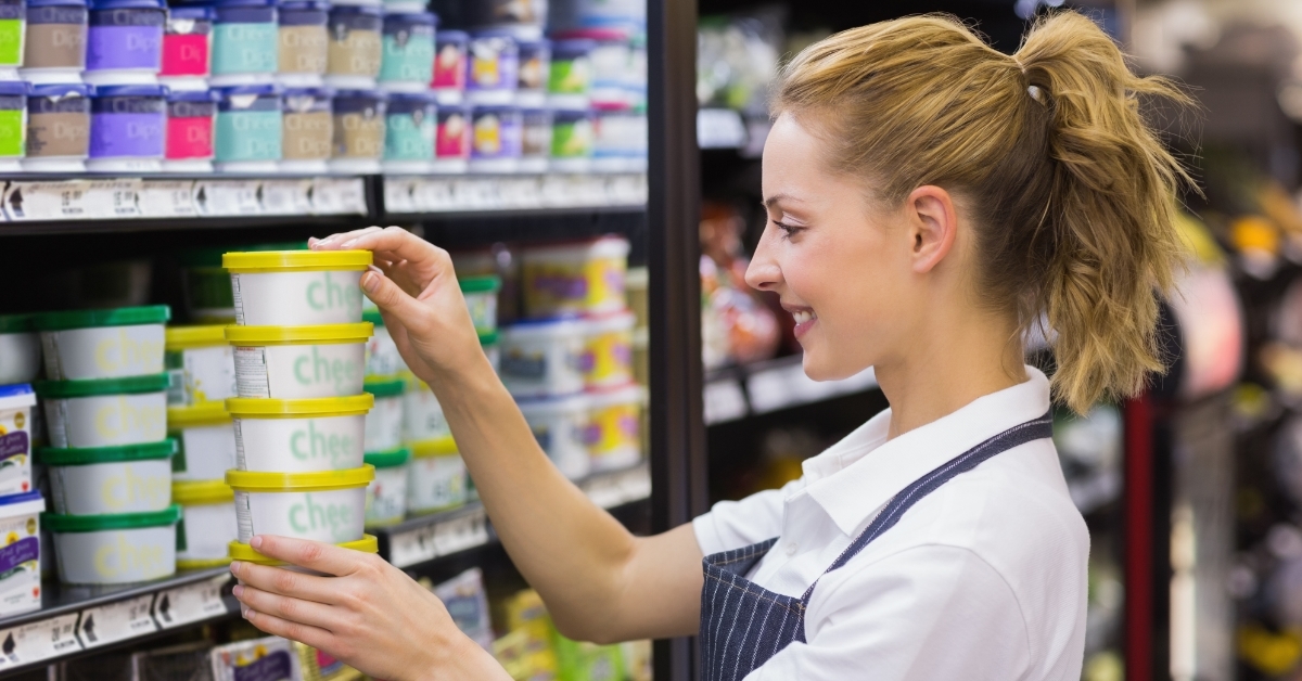 blonde worker keeping products in shelf