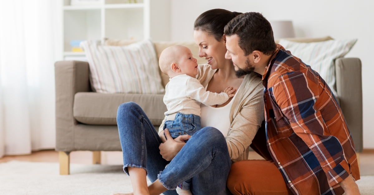 young couple having fun with baby