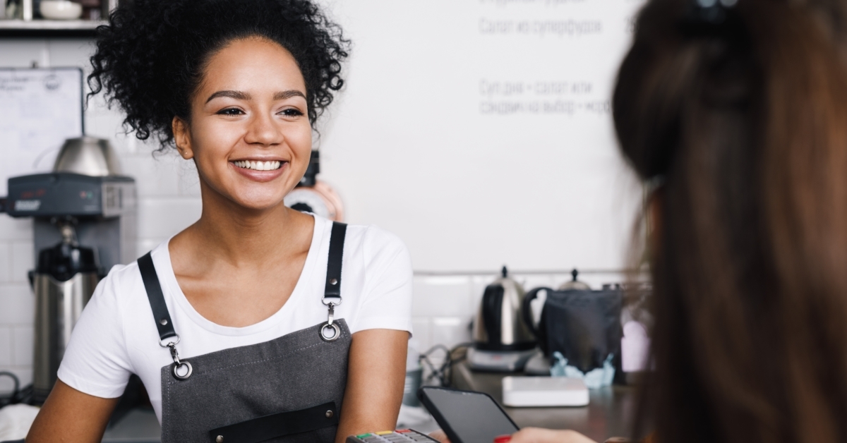 customer paying using phone at cafe