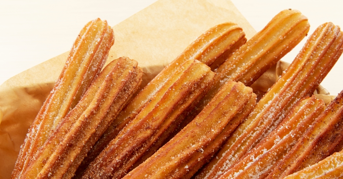 fresh churros in brown paper