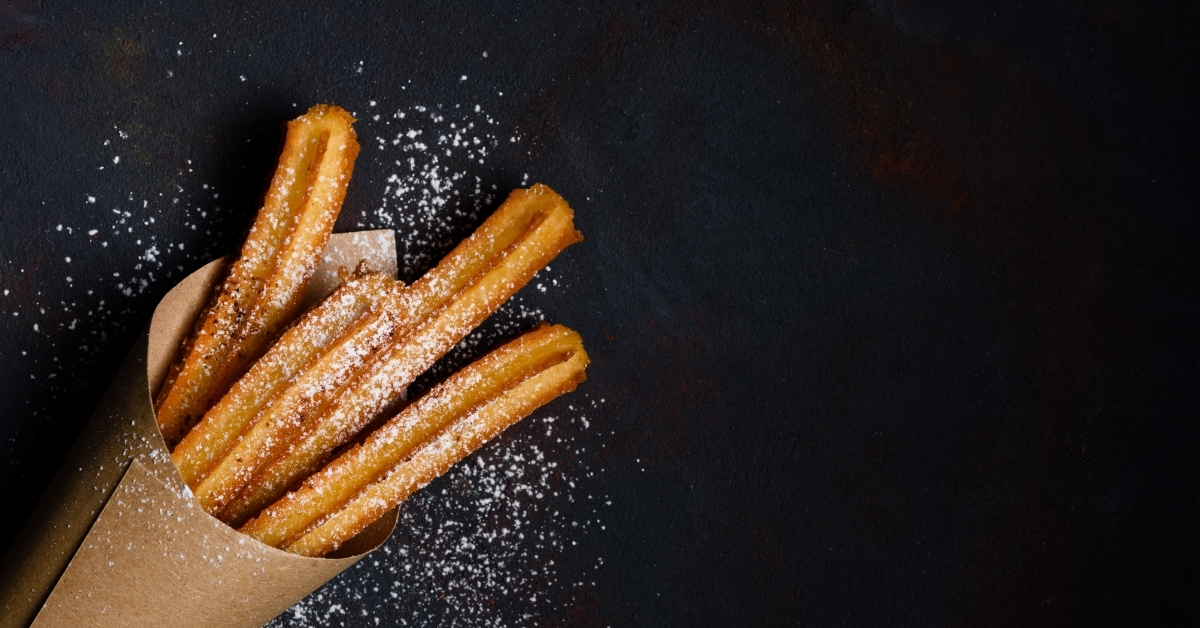 fresh Churros sticks on dark background