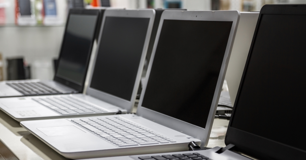 row of laptops in computer shop