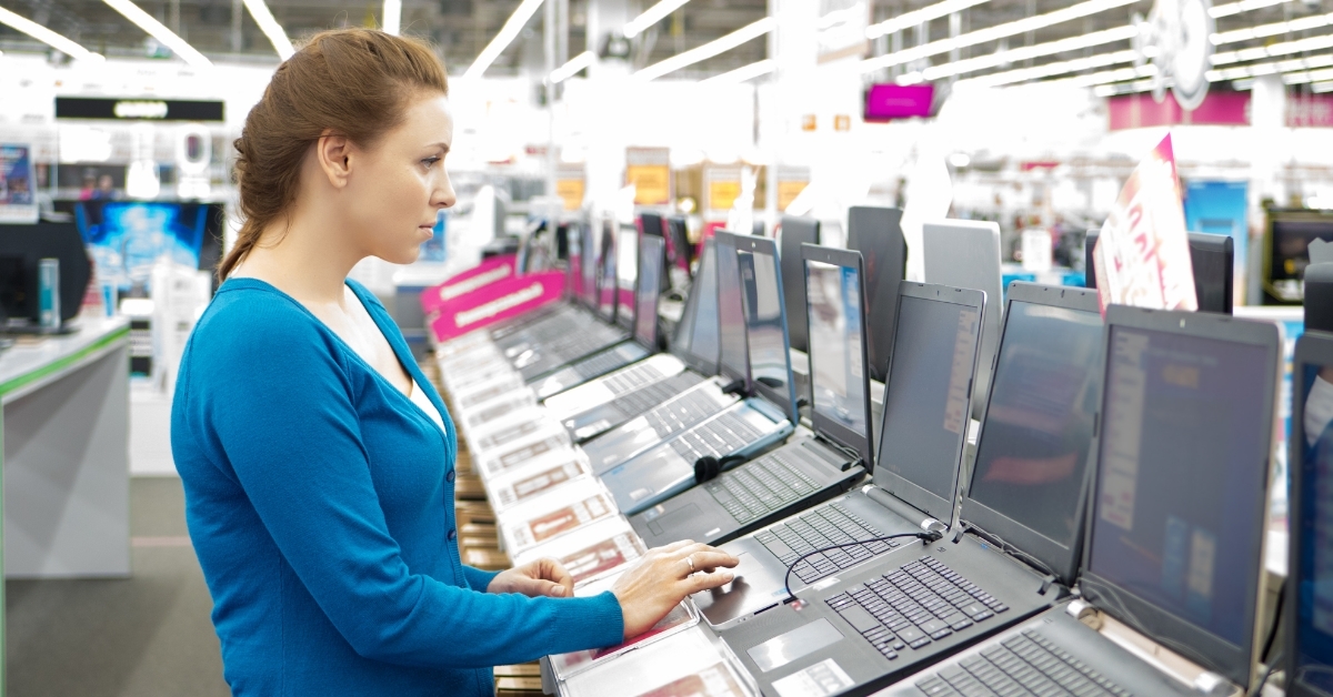 woman buying laptop in store