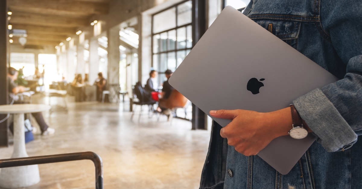 woman holding Apple MacBook Pro