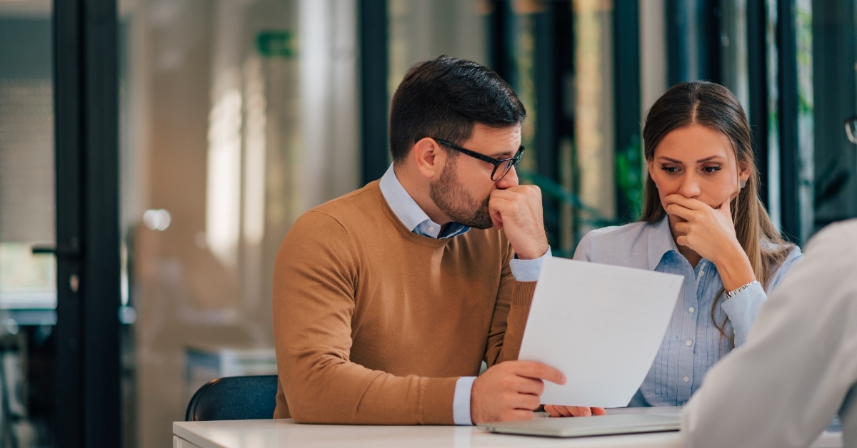 stressed couple reviewing bills together 