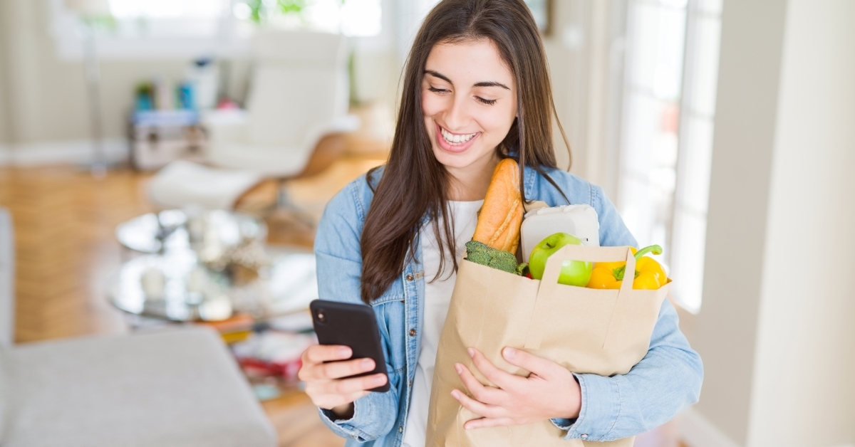 woman holding groceries paper bag