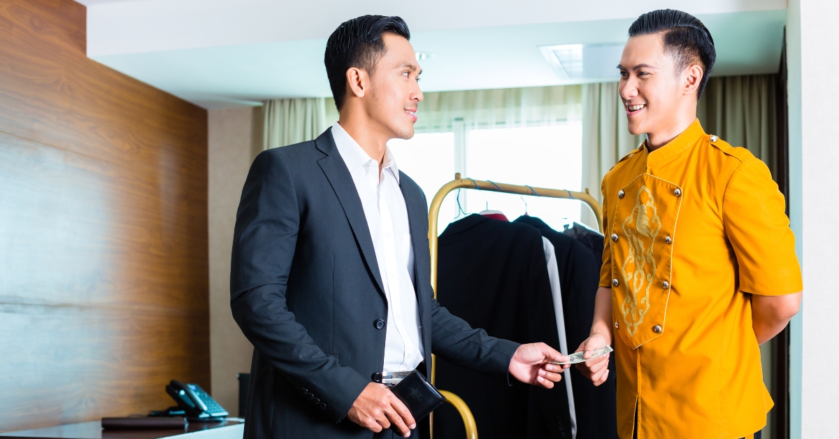 hotel bell boy servicing guest