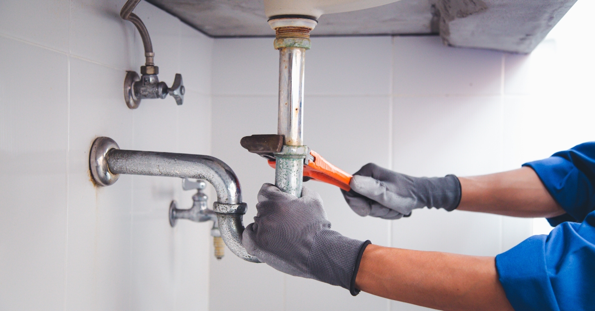 repairing water pipe using wrench