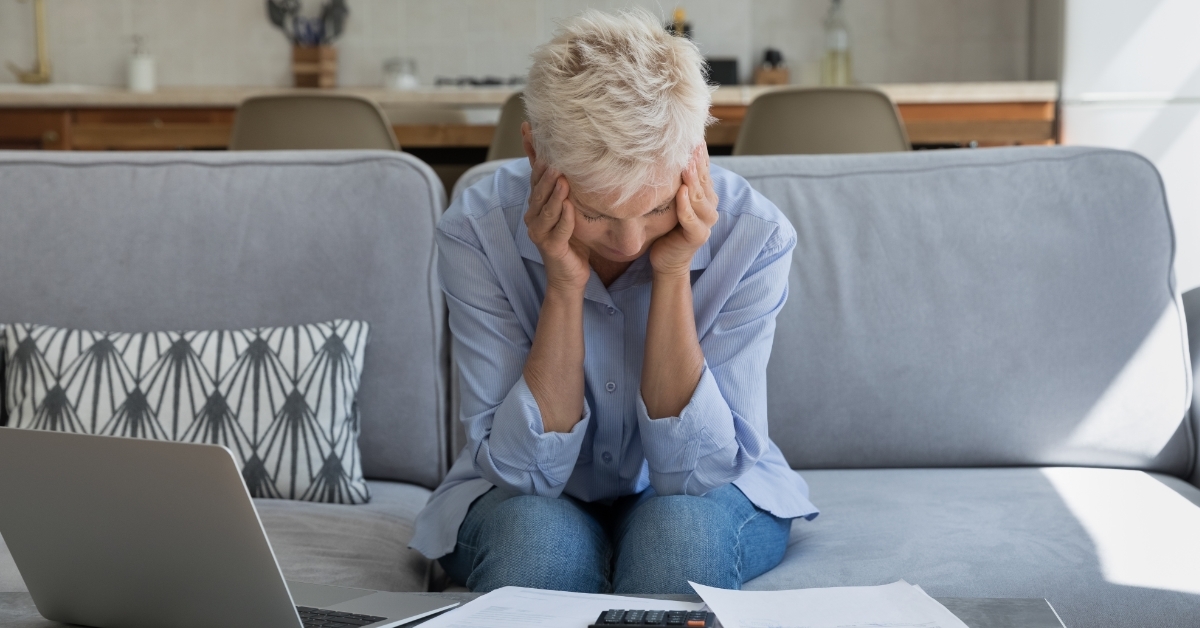 stressed female retiree sitting on couch