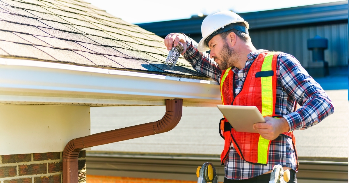 construction man inspecting house roof