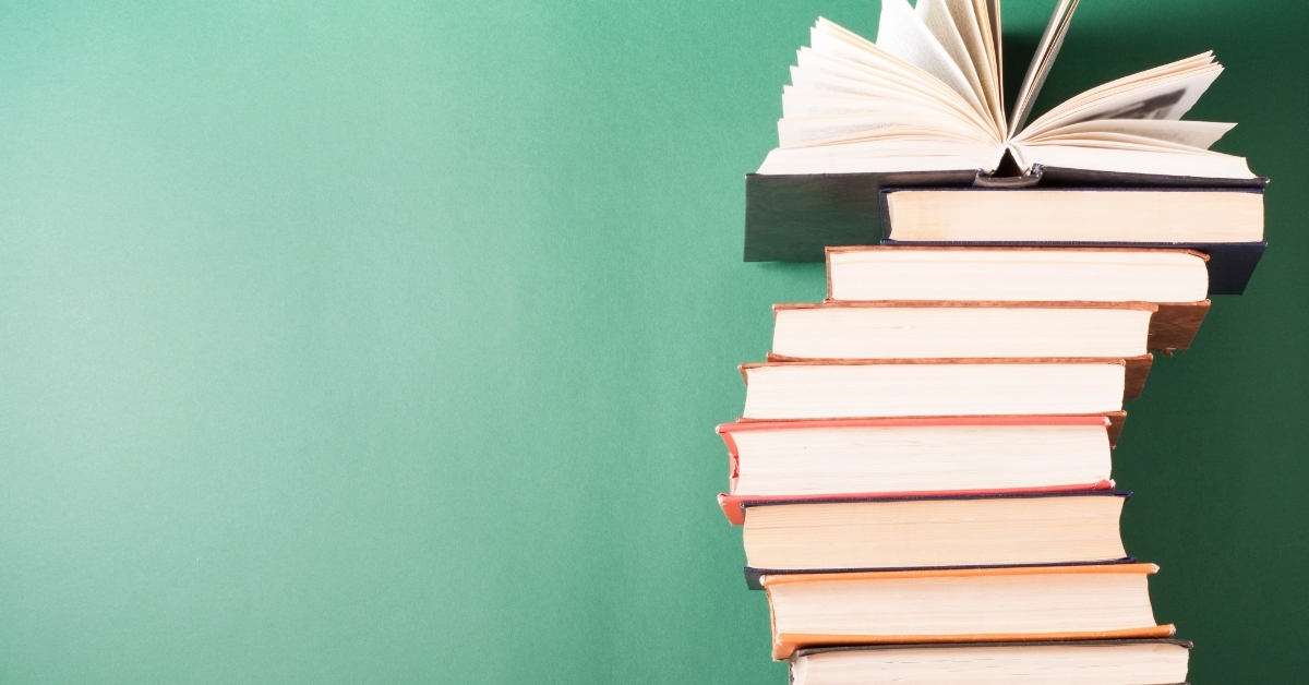 hardback books on wooden table