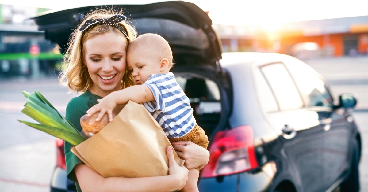 mother with son outside grocery store