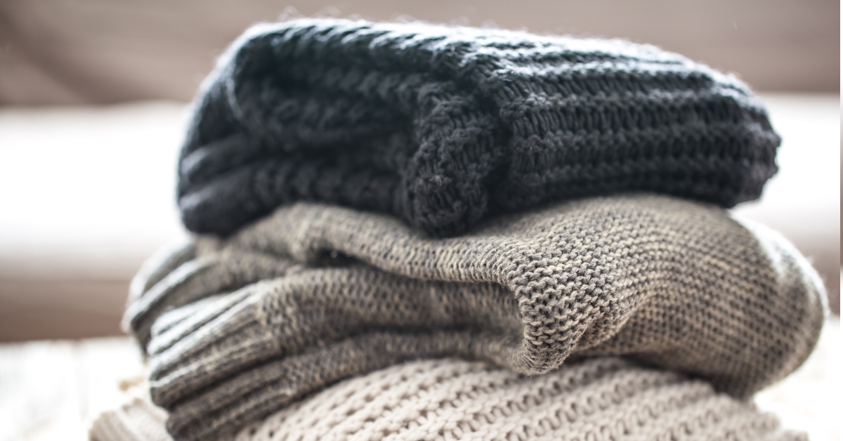 stack of cozy knitted sweaters