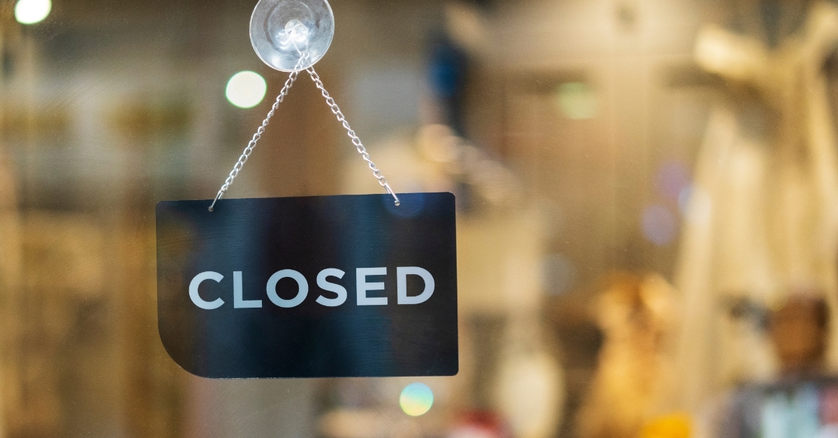 closed sign hanging outside restaurant