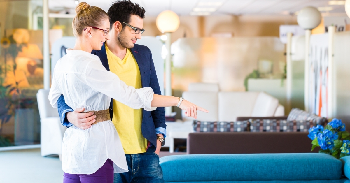 Couple buying couch in furniture store