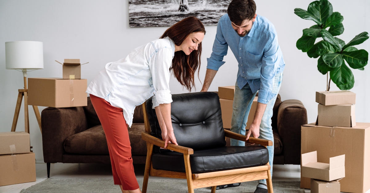 couple carrying modern chair