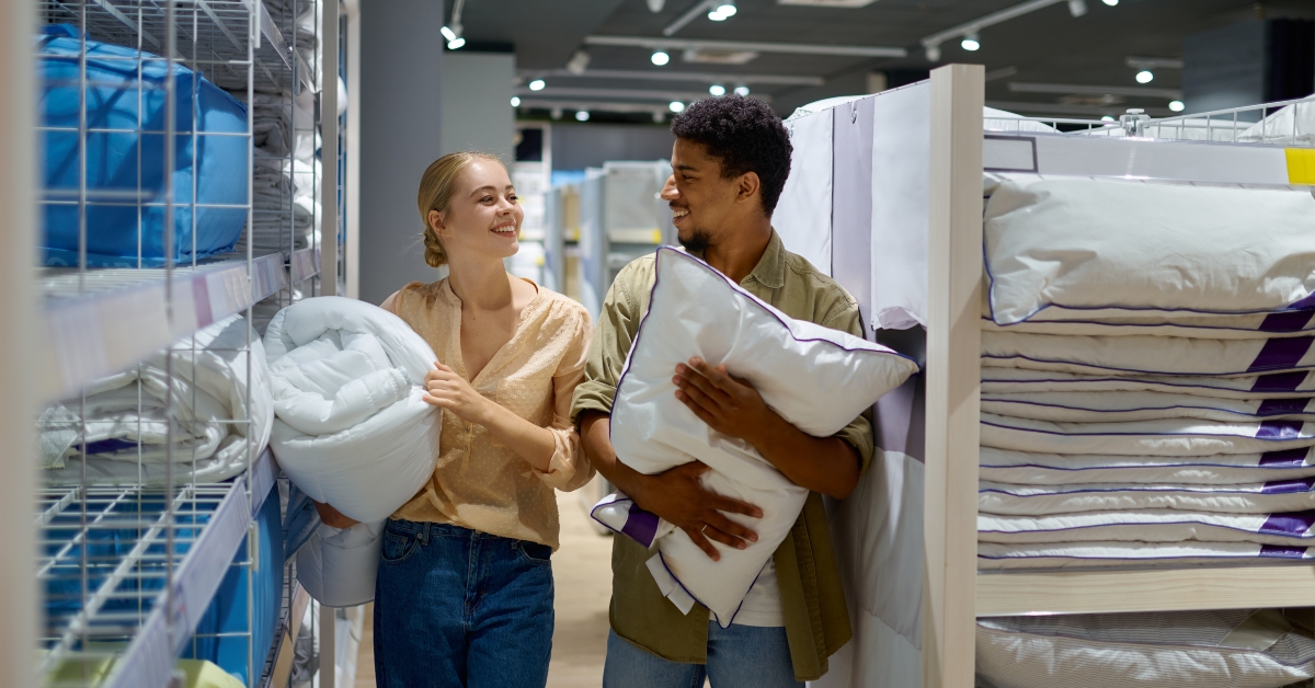 man and woman buying bedding