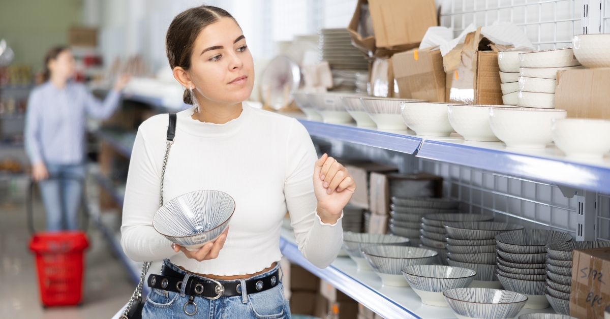woman in supermarket choosing plates