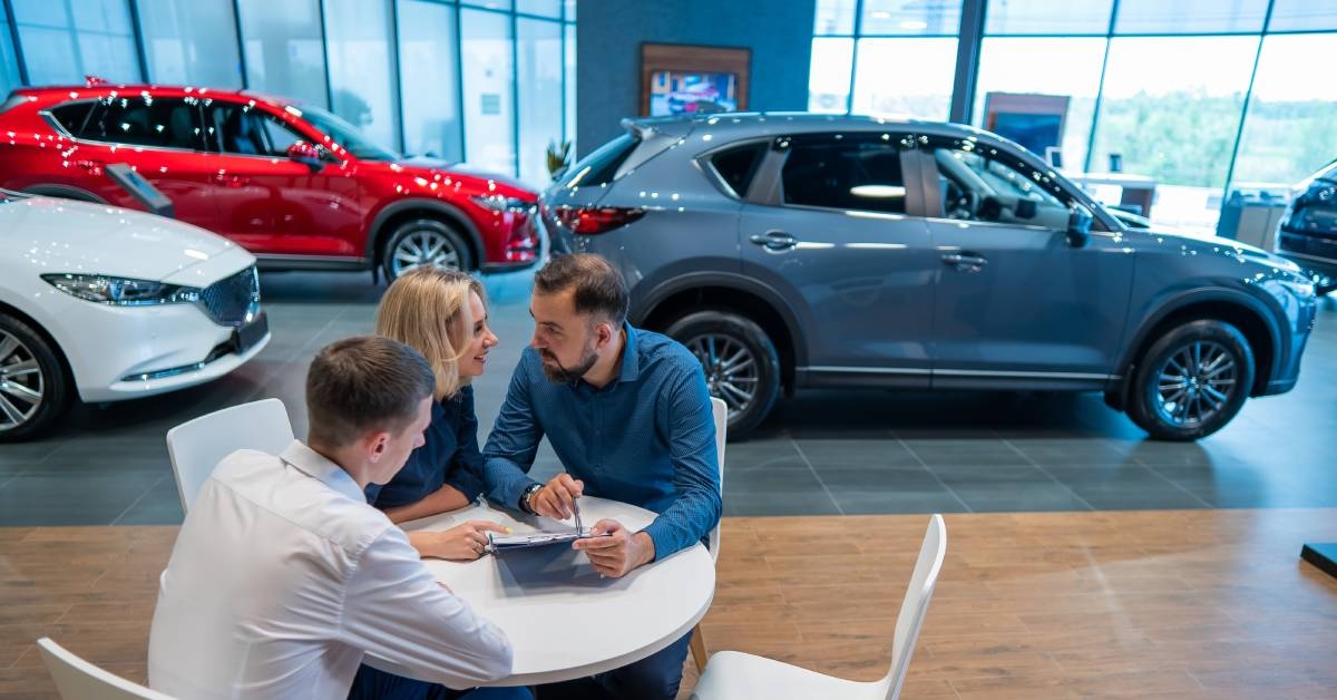 couple signs a contract for the purchase of a car