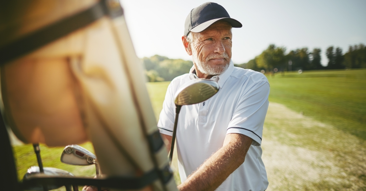 Senior man preparing to play golf
