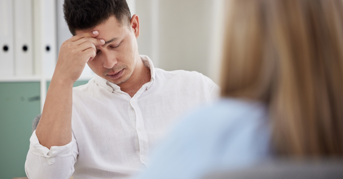 sitting in the clinic with his therapist