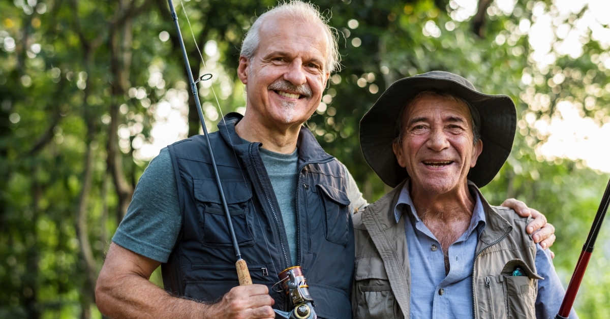 Senior friends fishing by lake