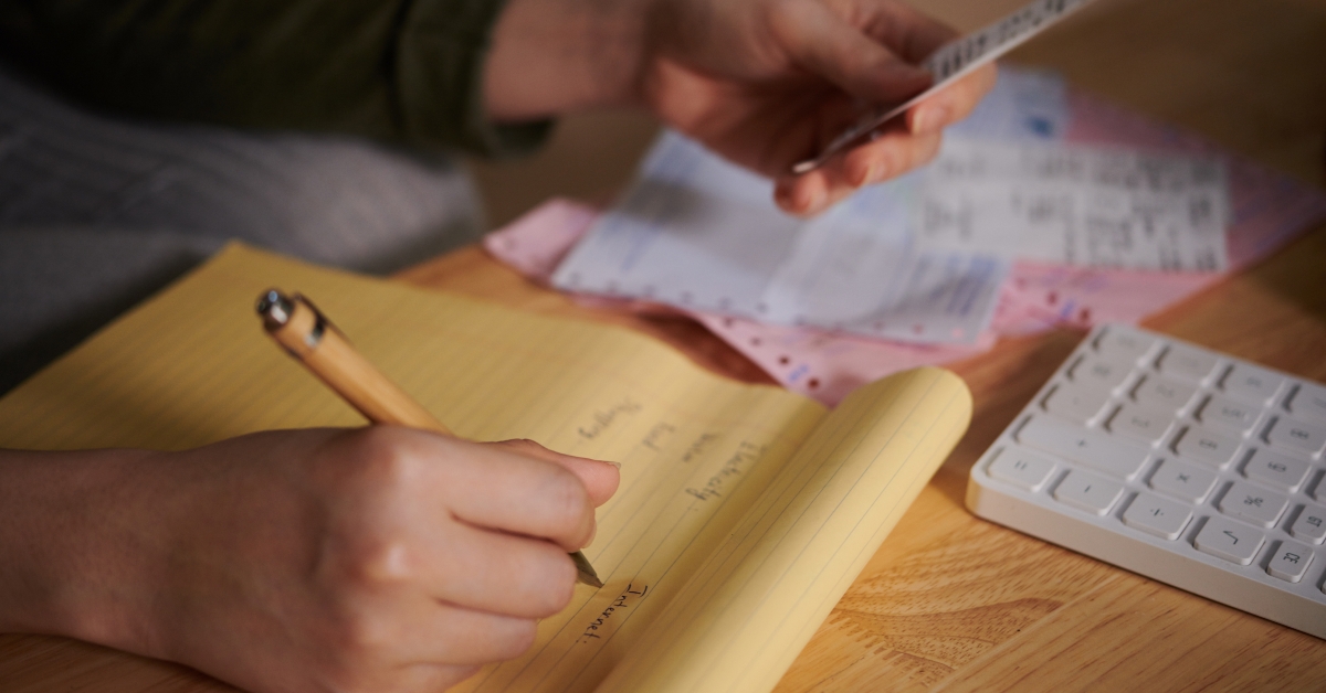 hand of woman checking paychecks