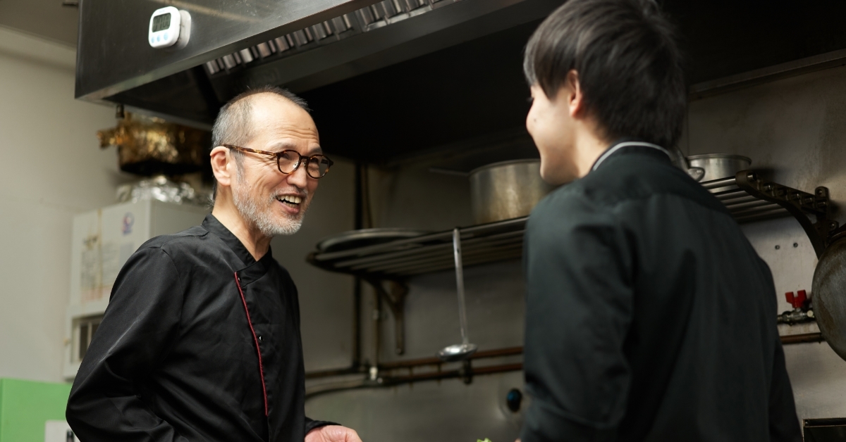 asian senior chef teaching junior chef