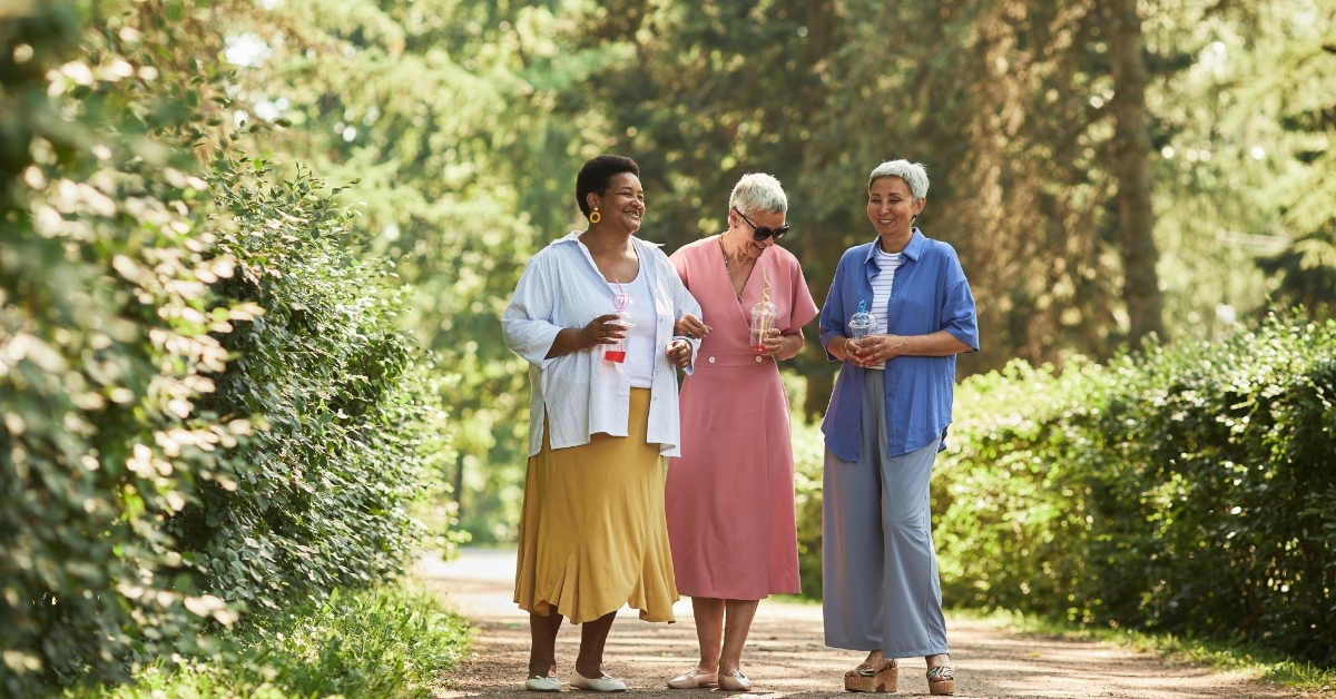 senior friends walking in park