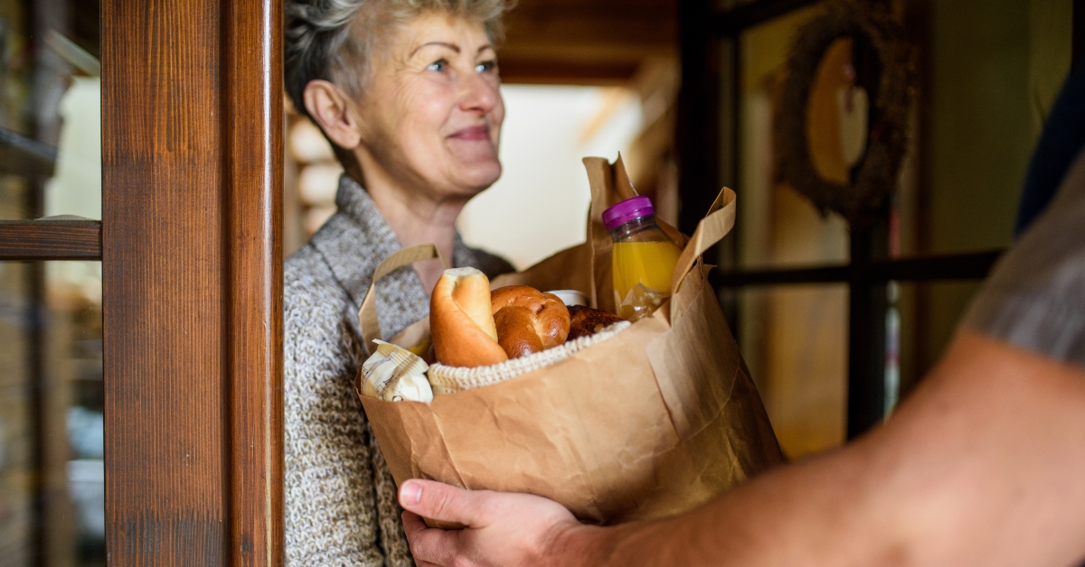 courier delivering to senior woman