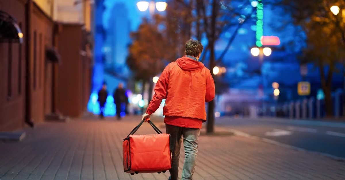 delivery boy walking on street