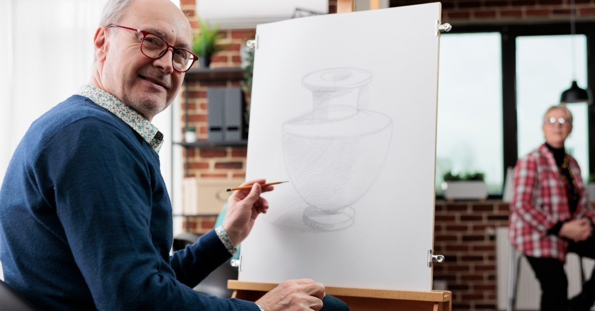 Happy senior man attending art workshop