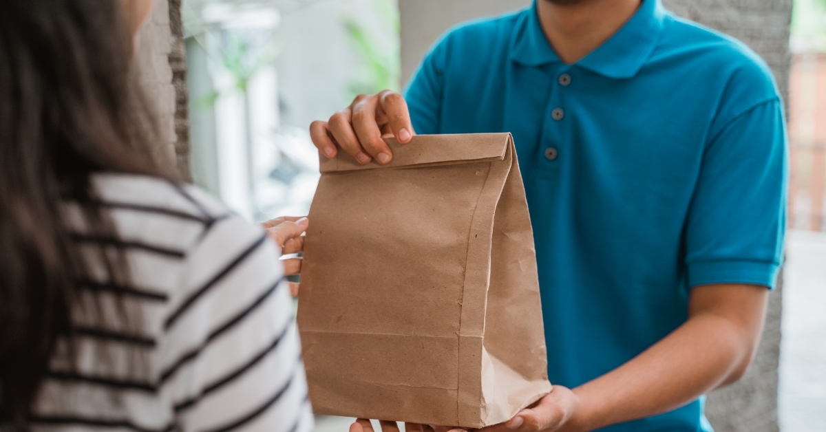 man delivering food to woman