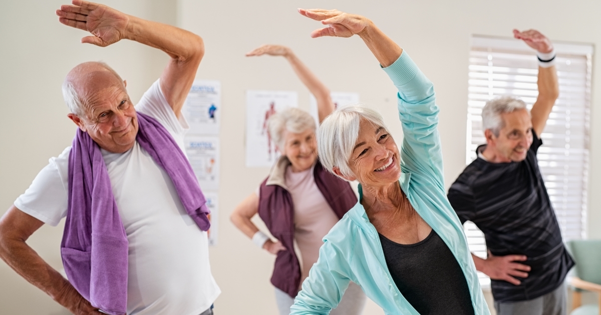 Senior people stretching at gym