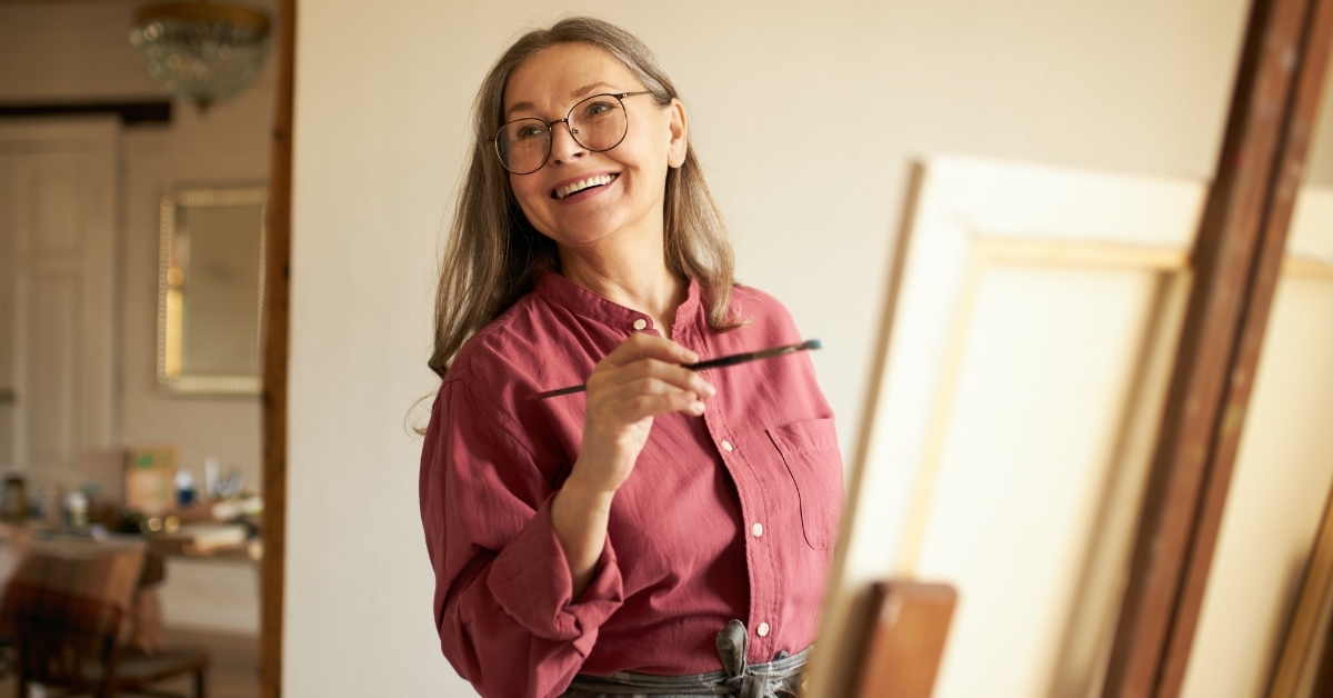 senior retired woman painting at home