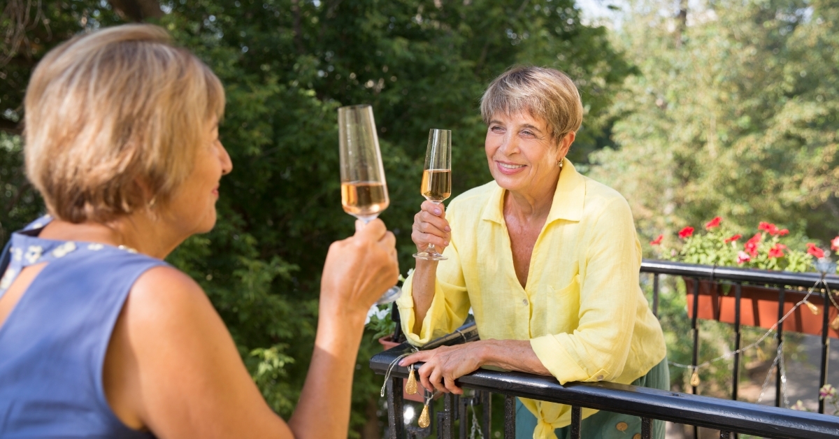 relaxed senior women chatting from balcony