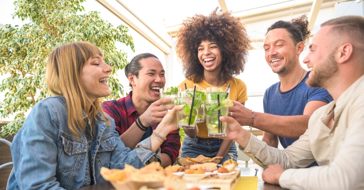 friends toasting mojito cocktails