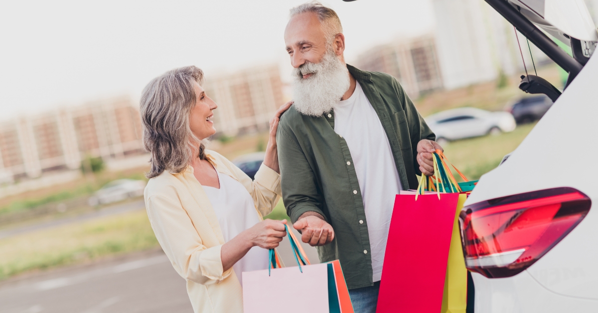 old couple holding shopping bags