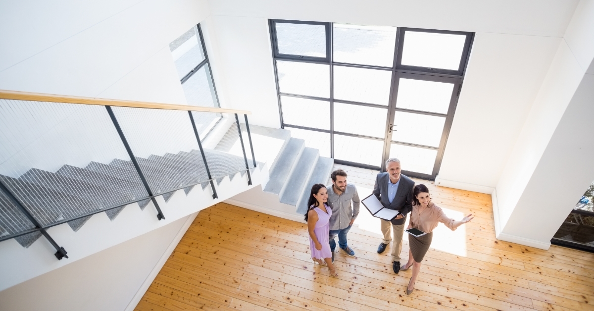 estate agent showing house to couple