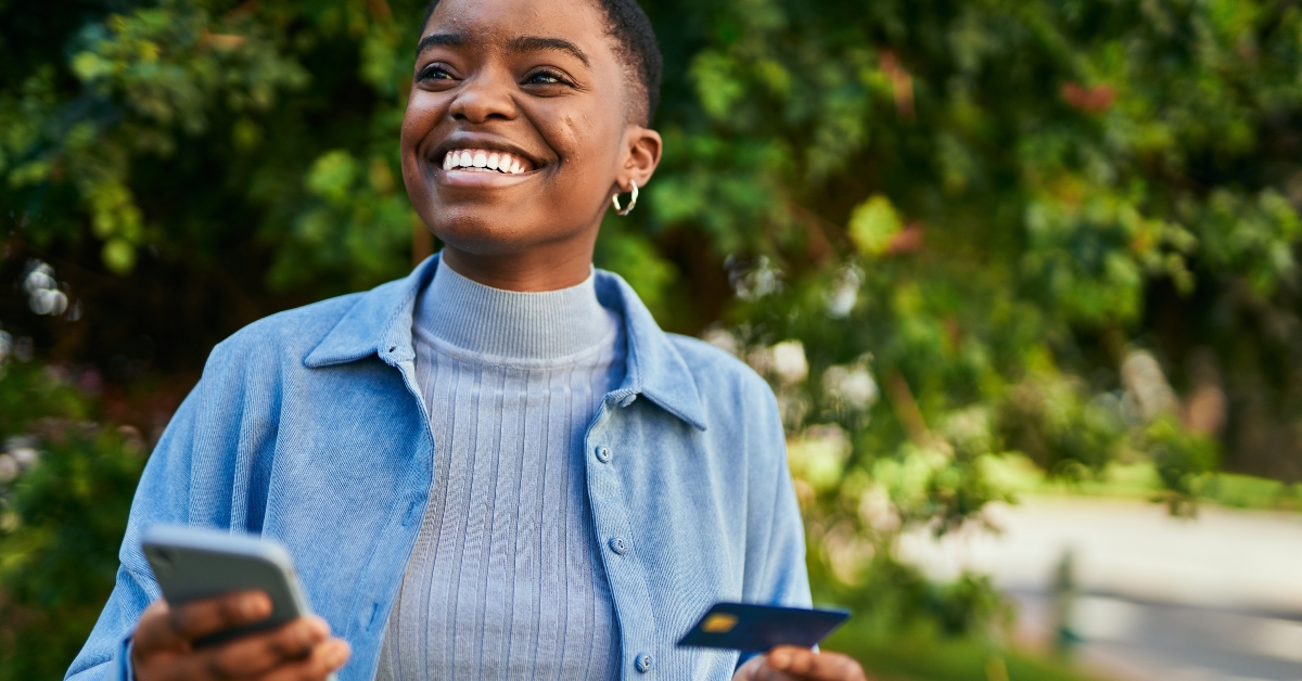 holding smartphone and credit card
