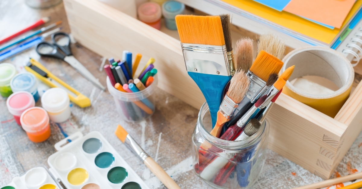 Paint brushes crafting supplies on table
