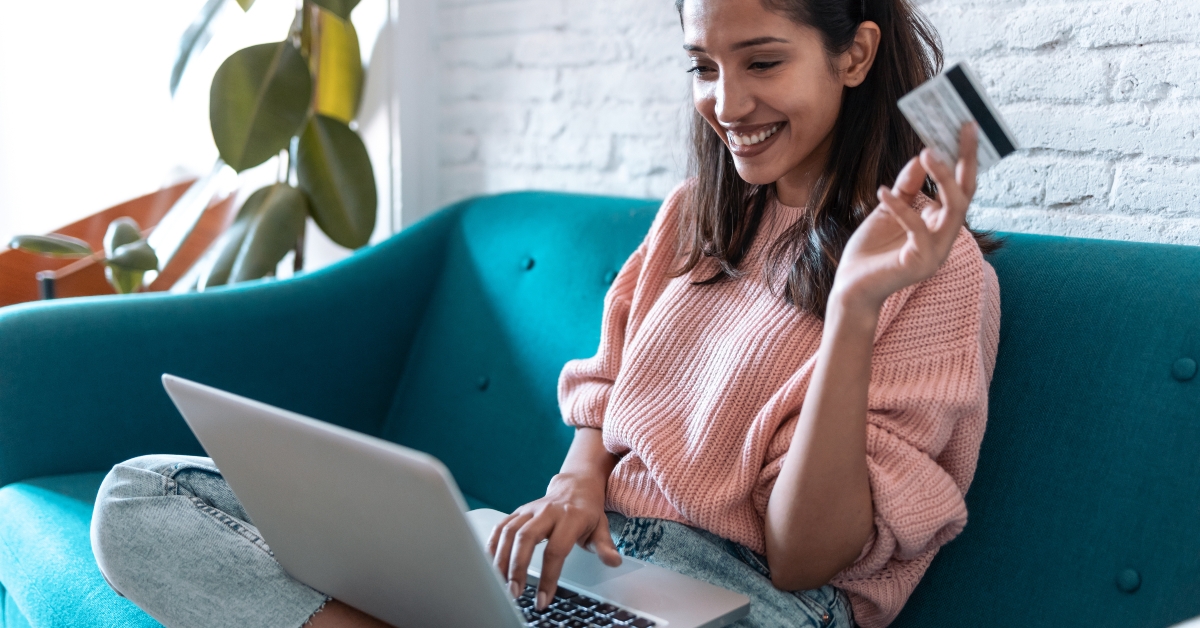 using laptop while sitting on sofa