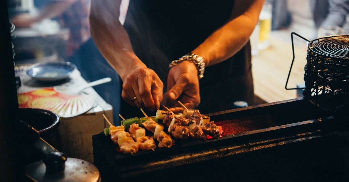 japanese man grilling meat stew